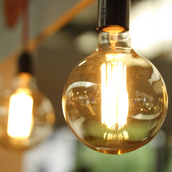 filament lightbulb on, orange light emitting, hanging lightbulbs, circle image